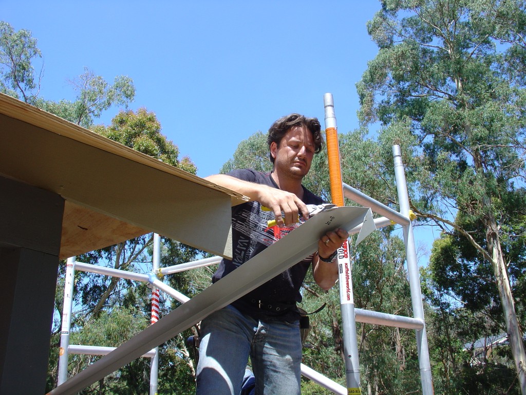 Using tin snips to cut the metal drip edge Using tin snips to cut the metal drip edge